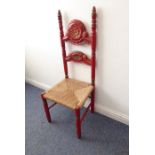 A mid-20th century red-painted and carved high-back chair with rush seat