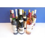 Twelve bottles of assorted French and other wines, some bottles very dusty (recently brought over