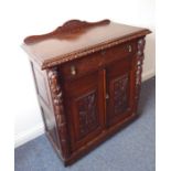 A late 19th century carved oak side cupboard in earlier style; galleried top above single full-width