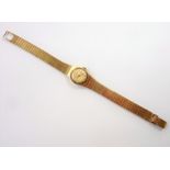 A ladies 9-carat yellow-gold-cased 'Eterna' dress wristwatch; the signed dial with baton markers,