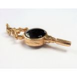 A 9-carat gold, onyx and mother-of-pearl watch key (The cost of UK postage via Royal Mail Special