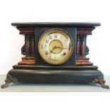 A decorative late 19th century ebonised and faux marble eight-day mantel clock on cast feet