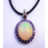 A 14-carat white-gold, large opal and amethyst pendant (The cost of UK postage via Royal Mail