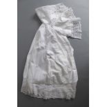 An early / mid-20th century christening gown; decorated with elaborate open lacework to the cuffs,