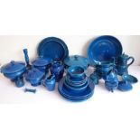 A French part dinner service by Quimper; comprising varying sized plates, lidded tureens, two-