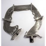 An 18-carat white-gold seven-strand bracelet set with diamonds (The cost of UK postage via Royal