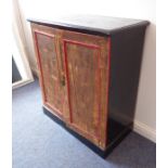 A late 19th/early 20th century painted side cabinet; the ebonised top above ebonised sides and