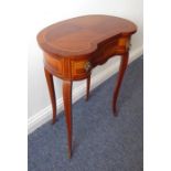 A French-style kidney-shaped occasional table; quarter veneered strung top above a single frieze