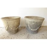 A large pair of circular, verdigrised stoneware garden planters; adorned with swags in the neo-