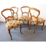 A set of four mid-19th century walnut balloon-back chairs having over-stuffed seats and moulded