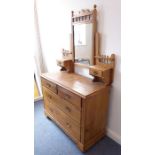 An early 20th century pine mirror-topped dressing chest; two half-width over two full-width