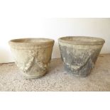 A large pair of circular, verdigrised stoneware, garden planters; adorned with swags in the neo-