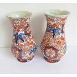 A pair of late 19th century Japanese baluster-shaped porcelain vases decorated in the Imari