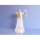 An Edwardian cut-glass claret jug with silver-plated mounts