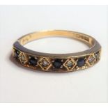 A 9-carat yellow-gold ring; horizontally set with five sapphires and four smaller diamond chips,