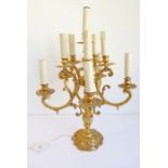 A gilt-metal eleven-light table candelabra fitted for electricity