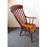 A 19th century lathe-back open armchair, shaped elm seat and turned tapering slightly splaying