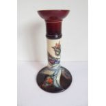 A Moorcroft Pottery table candlestick; tube-lined and decorated with stylised tulips, impressed
