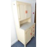 An original mid-20th century white-painted kitchen cabinet having an array of drawers and