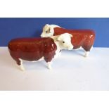 Two Beswick figures: a Hereford bull and cow (both marked 'CH. of CHAMPIONS', the bull 19cm long and