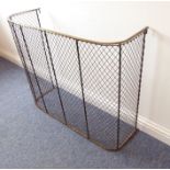 A late 19th/early 20th century brass-topped wire-mesh firescreen (90.5cm wide, 31cm deep, 76cm
