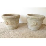 A large pair of circular, verdigrised stoneware, garden planters; each embossed with flower-head