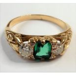 An 18-carat gold ring set with an emerald and two diamonds (The cost of UK postage via Royal Mail