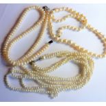 A good string of pearls with a yellow-metal clasp marked 14K, together with two other strings (3) (