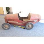 An early 20th century-style child's pedal racing car with steering, brake and side exhaust (
