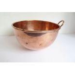 A 19th century circular copper bowl with single hanging handle; the bowl impressed Jones Bros. 4