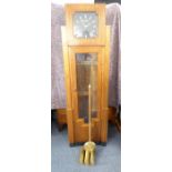 An Art Deco-style French grandfather clock, the geometric black dial with baton markers and signed
