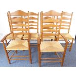 In the style of Ernest Gimson, a set of six (4 + 2) oak ladderback chairs each with rush seats and