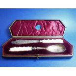A late 19th/early 20th century boxed mother-of-pearl handled and silver butter knife and spoon