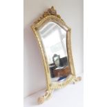 A large and decorative wall-hanging mirror having a moulded pediment depicting flower heads and