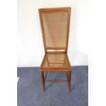 A late 19th century child's wooden chair (possibly fruitwood?) with high rattan-caned back and seat,