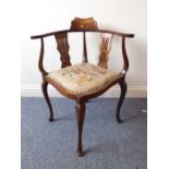 An Edwardian mahogany corner chair; two pierced splats, floral needlework seat and the outset arms