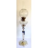 A circa 1900 silver-plated oil lamp; electrical conversion, clear cut-glass oil container and