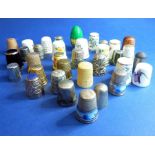 An interesting collection of various thimbles to include treen, white metal, silver and bone etc.