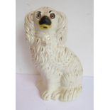 A 19th century Staffordshire pottery spaniel having glass eyes