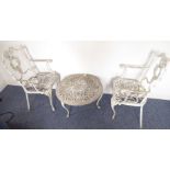 Circular low garden table together with two garden chairs