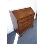 A late 18th century mahogany writing bureau; the angular fall opening to reveal fitted interior with