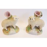 A pair of early 19th century Staffordshire pottery spill vases modelled as sheep