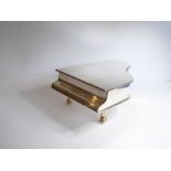 A 1950s silver-plated music box in the shape of a grand piano