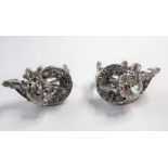 A superb pair of Deco diamond earrings; each set with 1-carat centre stone surrounded by baguette