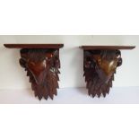 A pair of carved wood wall brackets modelled as ram's heads in Robert Adams style (32cm high)