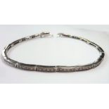 A white-gold and diamond tennis bracelet (The cost of UK postage via Royal Mail Special Delivery for