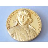 A gilt bronze medallion depicting Napoleon I in relief (9.5cm diameter) (The cost of UK postage