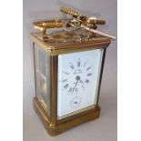 A fine-quality French brass and glass-sided carriage alarm clock; the white-enamel dial with Roman