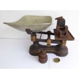 A set of early 20th century cast-iron weighing scales together with various weights (the scales to