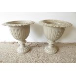 A pair of cast-iron garden urns; each with outset leaf-style border and circular foot (48cm high) (
